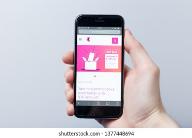 New York / USA - 04.14.2019: A hand holding a smartphone which displays Telstra logo on the official website homepage. Telstra logo visible on smartphone screen. Illustrative editorial
