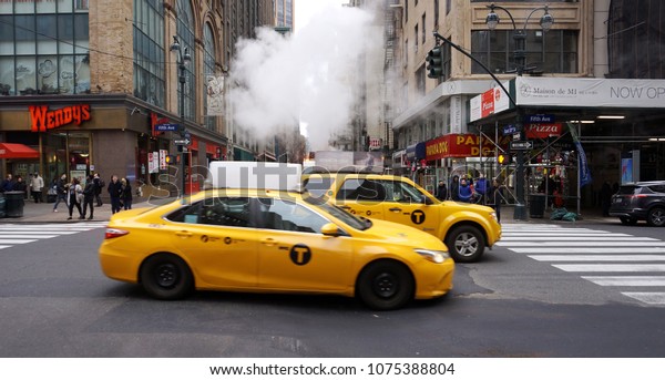 New York, New York/ USA - 04192018 : Taxis and\
smoke in Manhattan