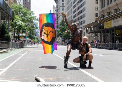 New York, New York USA - 06-27-2021 2 Young Beautiful Black Females Holding A Pride Flag At The 2021 NYC Pride Parade