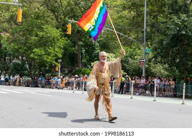 New York, New York USA - 06-27-2021 Man With Rainbow Flag Walking At The 2021 Nyc Pride Parade