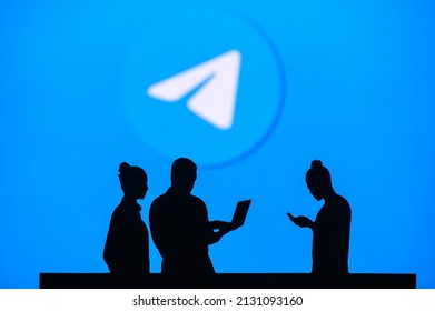 NEW YORK, USA, 1. MARCH 2022: ​​Telegram App, Group Of Business People Chat On Mobile Phone And Laptop. ​​Telegram – Freeware, Cross-platform, Cloud-based Instant Messaging. Company Logo On Screen