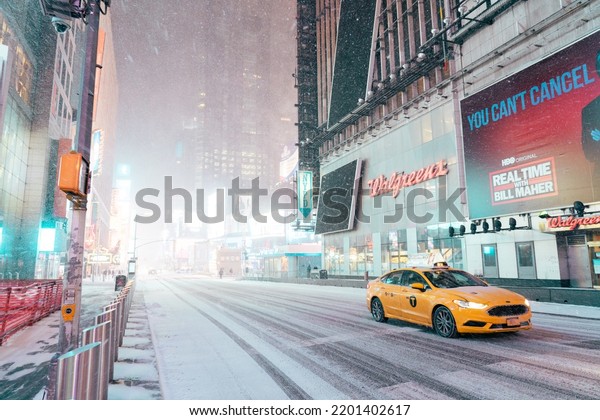 New York, New York USA 1.3.2021: NYC\
Taxi drives through Times Square during a\
snowstorm.