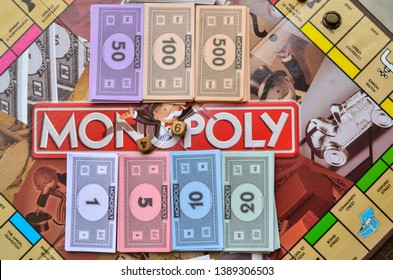 New York, USA, 2019. Fake Currency Notes/ Paper Money And Dice Neatly Arranged On Monopoly Board Game Playing At Home In Quarantine During Lockdown 