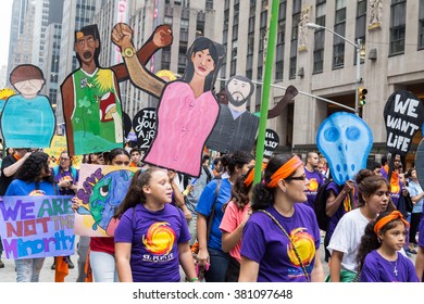 New York, USA - 21 September 2014:  People Carry Posters Of Characters Representing Different Ethnic Groups Whilst Campaigning For Environmental Awareness During The Peoples Climate March