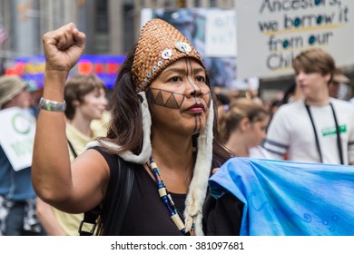 New York, USA - 21 September 2014:  Woman With Raised Fist And Face Paint Marches And Campaigns For Greater Environmental Awareness During The Peoples Climate March Through New York City