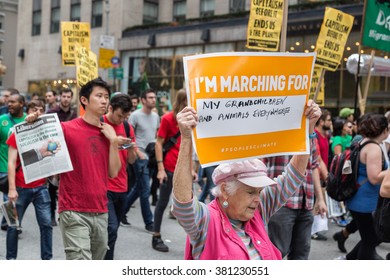 New York, USA - 21 September 2014:  Grandmother Carries A Banner Whilst Marching And Campaigning For Greater Environmental Awareness During The Peoples Climate March Through New York City