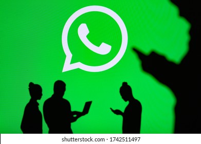 NEW YORK, USA, 25. MAY 2020: WhatsApp Cross-platform Messaging And Voice Over Service Group Of Business People Chat On Mobile Phone And Laptop. Company Logo On Screen In Background