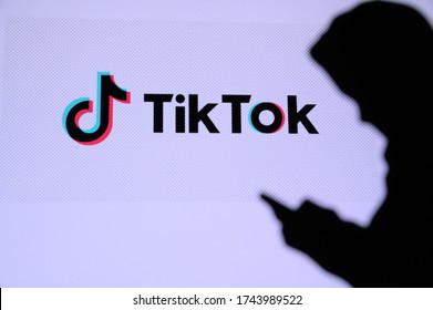 NEW YORK, USA, 25. MAY 2020: TikTok, Chinese video-sharing social networking service Young boy chat on mobile phone. Company logo on screen in background