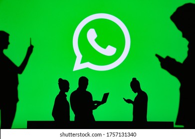 NEW YORK, USA, 25. MAY 2020: WhatsApp Cross-platform Messaging And Voice Over Service Group Of Business People Chat On Mobile Phone And Laptop. Company Logo On Screen In Background