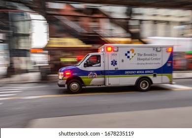 NEW YORK, USA. 29th March. An Ambulance In A Emergency Transporting A Coronavirus Infected Person To The Hospital In New York City. The Driver Is Wearing All Kind Of Protecting Clothes 