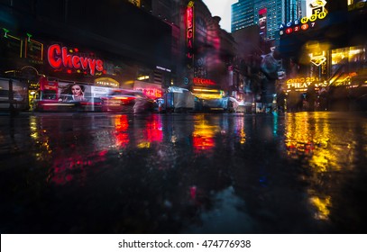 NEW YORK, USA - Apr 30, 2016: Lights and shadows of New York City. NYC streets after rain with reflections on wet asphalt