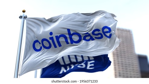 New York, USA, April 14 2021. Flags of Coinbase and NYSE flying in the wind. On April 14, 2021, Coinbase went public on the Nasdaq exchange via a direct stock listing