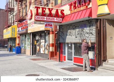 NEW YORK, USA - AUGUST 17, 2015: Man Opening Shop In Harlem District. Since The 1920s, Harlem Has Been Known As A Major African American Residential, Cultural And Business Center. 