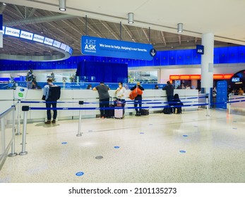 New York, USA - December 25, 2021: Horizontal View of the Information Help Desk of Terminal 5 of John F. Kennedy Airport with Travelers Being Helped.