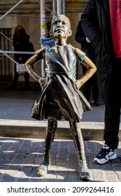 NEW YORK, NEW YORK, USA - DECEMBER 27, 2021: Fearless Girl, A Bronze Sculpture By Kristen Visbal, Outside The New York Stock Exchange.