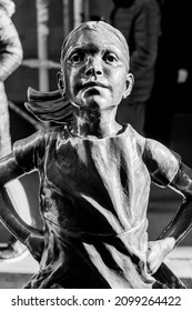 NEW YORK, NEW YORK, USA - DECEMBER 27, 2021: Fearless Girl, A Bronze Sculpture By Kristen Visbal, Outside The New York Stock Exchange.