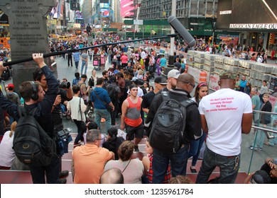 New York, New York / USA - February 16, 2013: Tourists Taking Photographs Of Times Square. Times Square Is Best Known For Being The Epicenter Of Dick Clark's New Year's Eve (NYE) Ball Drop Countdown.