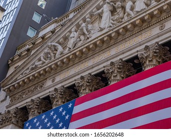 New York, USA February 17, 2020 Famous Wall Street And The Building In New York, New York Stock Exchange With Patriot Flag