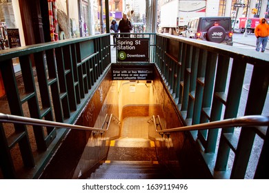 New York, New York / USA - Jan 10, 2020:  Stairwell entrance to the downtown Spring Street subway station in the neighborhood of Little Italy.