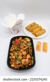 New York, New York USA - January 1 2022: Chinese Takeout With Mala Chicken A Box Of Rice And Spring Rolls With Sauce Packets