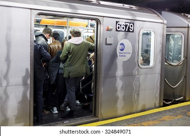 New York, New York, USA - January 7, 2012: People Can Be Seen Standing And Seated In This Manhattan Subway Car With Open Doors.