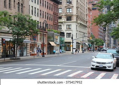 NEW YORK, USA - JULY 1, 2013: People Walk Along Madison Avenue In New York. Madison Avenue Is One Of The Most Recognized Fashion Shopping Destination In The World.