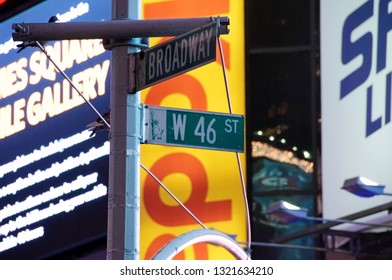 New York, New York / USA - July 13, 2010: A Street Sign Depicting The Corner Of Broadway And West 46th Street In New York City's Famous Times Square At Night With Brightly Lit Commercial Billboards.