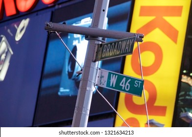 New York, New York / USA - July 13, 2010: A Street Sign Depicting The Corner Of Broadway And West 46th Street In New York City's Famous Times Square At Night With Brightly Lit Commercial Billboards.