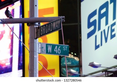 New York, New York / USA - July 13, 2010: A Street Sign Depicting The Corner Of Broadway And West 46th Street In New York City's Famous Times Square At Night With Brightly Lit Commercial Billboards.