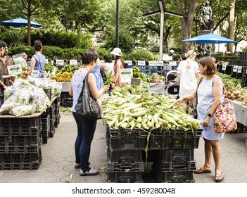 New York, New York, USA - July 15, 2016: People Looking Over Corn And Other Goods At The Union Square Green Market Farmers Market.