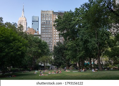 New York, New York / USA - July 2 2020: Green Grass Field At Madison Square Park With People Tanning And Relaxing In New York City During Summer