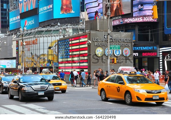 NEW YORK, USA - JULY 2, 2013: Taxis drive along
Times Square in New York. Times Square is one of most recognized
landmarks in the world. More than 300,000 people pass through Times
Square daily.