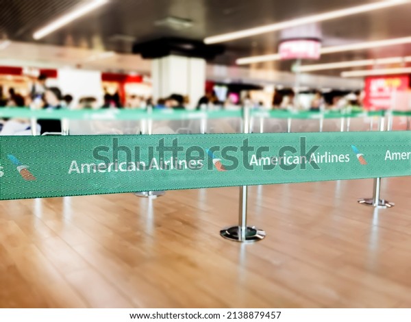 New York, USA, July\
2021: Green belt barrier with white American airlines airlines\
logo. American Airlines is a major US-based airline. Travel and\
airport security