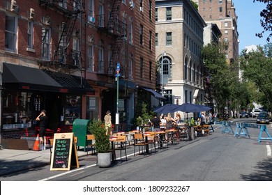 New York, New York / USA - July 25 2020: Outdoor Street Dining Seating Area At Restaurants On A Closed Off Street In Greenwich Village During The Covid 19 Outbreak In New York City