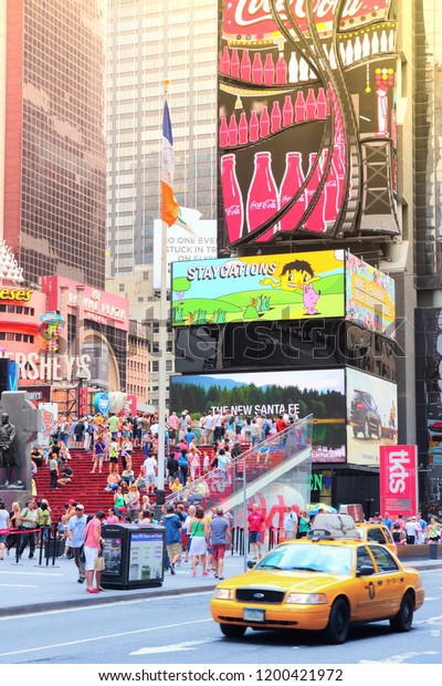 NEW\
YORK, USA - JULY 4, 2013: People visit Times Square in New York.\
Times Square is one of most recognized landmarks in the world. More\
than 300,000 people pass through Times Square\
daily.