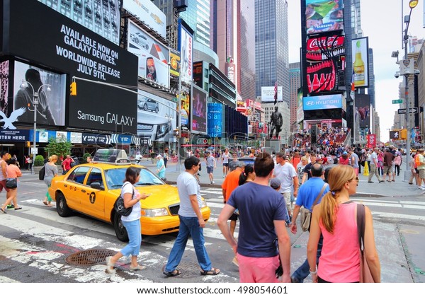 NEW\
YORK, USA - JULY 4, 2013: People visit Times Square in New York.\
Times Square is one of most recognized landmarks in the world. More\
than 300,000 people pass through Times Square\
daily.