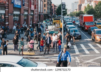 New York, USA - June 01, 2018: People Walking On A Street In Harlem, NYC. Since The 1920s, Harlem Has Been Known As A Major African American Residential, Cultural And Business Center. 