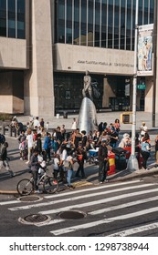 New York, USA - June 01, 2018: People By The Statue Of Adam Clayton Powell Jr. In Harlem, NYC. Since 1920s Harlem Is A Major African American Residential, Cultural And Business Center Of New York.