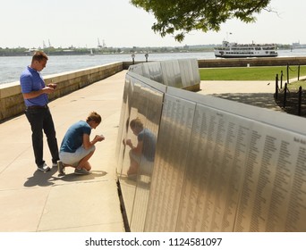 New York, USA - June 09, 2018: People Look On The American Immigrant Wall Of Honor Is Located At The Ellis Island National Museum. 