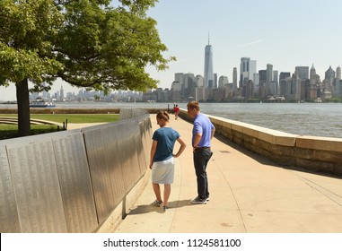 New York, USA - June 09, 2018: People Look On The American Immigrant Wall Of Honor Is Located At The Ellis Island National Museum. 