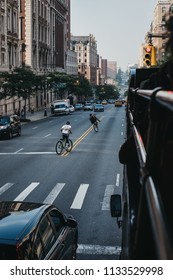 New York, USA - June 1, 2018: Teenagers Riding Bikes On The Road In Harlem, New York. Since The 1920s, Harlem Has Been Known As A Major African American Residential, Cultural And Business Center. 