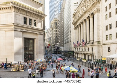 New York, USA - June 18, 2016: Wall street and the New York Stock exchange in New York City with hot dog stands