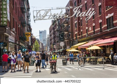 New York, USA - June 18, 2016: Busy street with pedestrians in Little Italy with a welcome sign in New York City