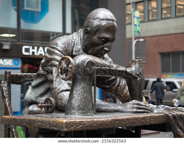 New York, USA\
- June 19, 2019: Image of The Garment Worker, a sculpture situated\
on 7th Avenue also known as Fashion Avenue in Manhattan. The\
sculpture was created by Judith\
Weller.
