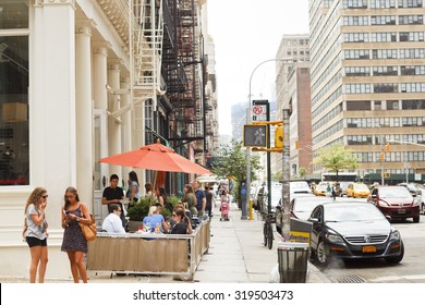 New York, New York, USA - June 20, 2011: Diners At Outdoor Seating At A Restaurant On Church Street In The Tribeca Section Of Lower Manhattan. People Can Be Seen On The Street.