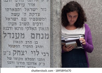 New York, USA - June 2013
Religious Jewish Young Woman Praying Near The Lubavitch Rebbe Menahem Mendel Grave During The Guimel Tamuz Ceremony.
Translation: Here Is Buried The Seventh Lubavitcher Rebbe