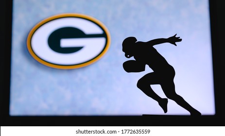 NEW YORK, USA, JUNE 23. 2020: Green Bay Packers. Silhouette of professional american football player. Logo of NFL club in background, edit space.