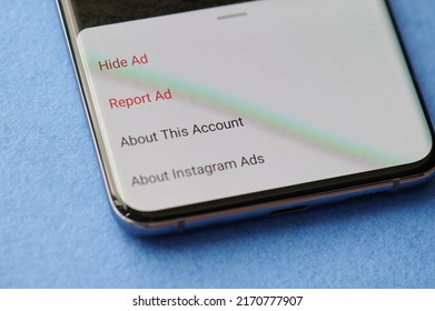 New york, USA - June 28 2021: Reporting ads in Instagram  app menu  on smartphone screen close up