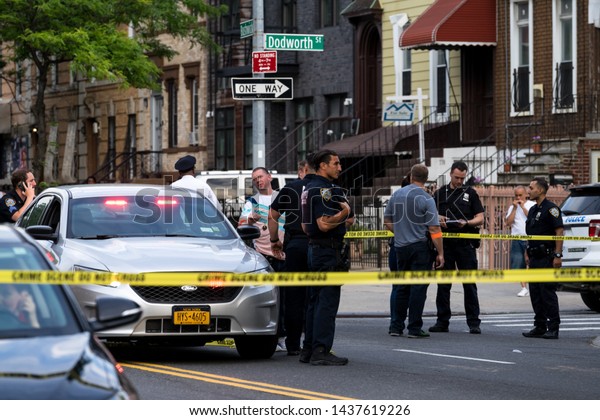 New York / USA - June 29\
2019: Police works at the crime scene, man was shot at the Bushwick\
avenue