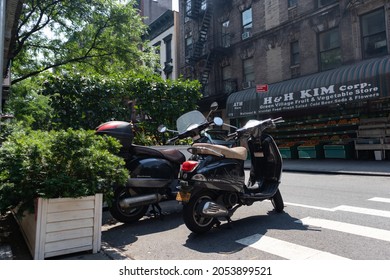 New York, New York USA - June 7 2021: Mopeds Parked Along The Street In Greenwich Village Of New York City With A Bodega